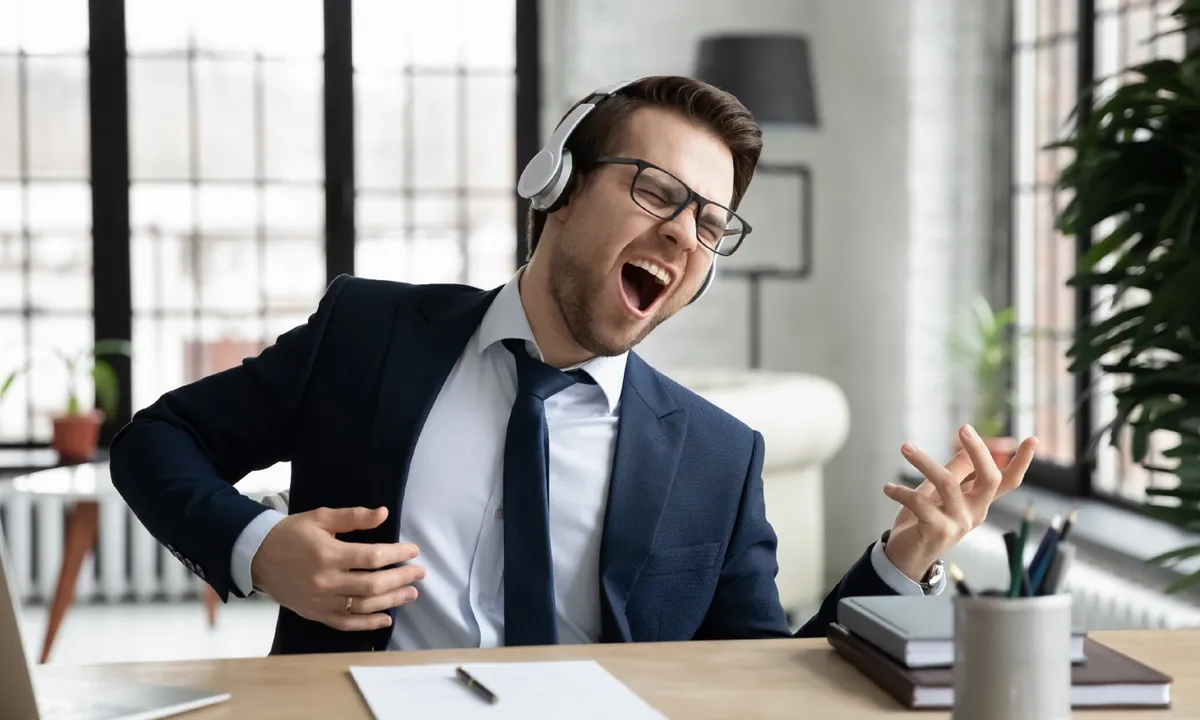 playing air guitar instrument at work