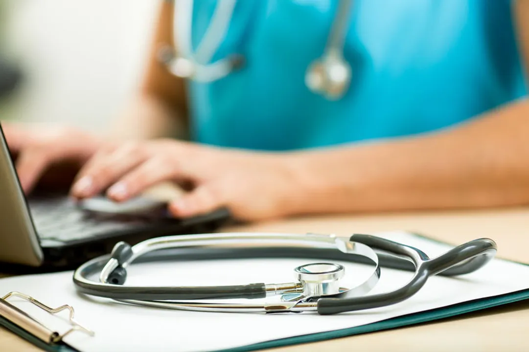 close up of a physician searching for jobs with laptop