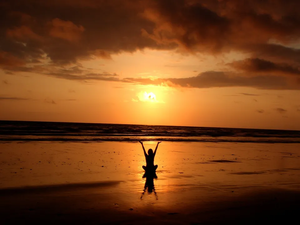 A woman on the beach, represents wellbeing