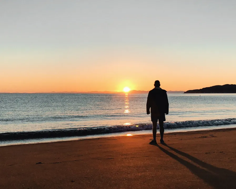 Man overlooking sunset on the ocean