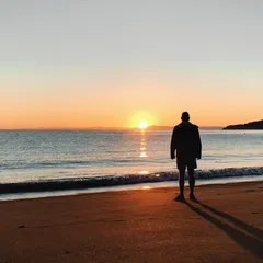 Man overlooking sunset on the ocean