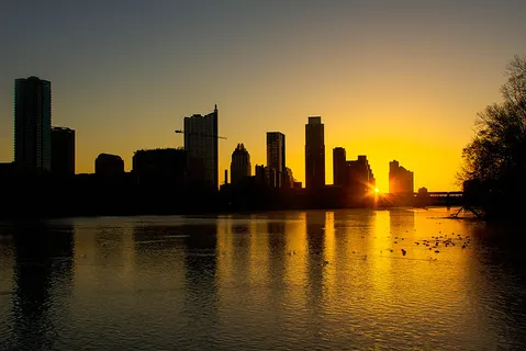 The skyline of Austin, TX viewed at sunrise from Zilker Park