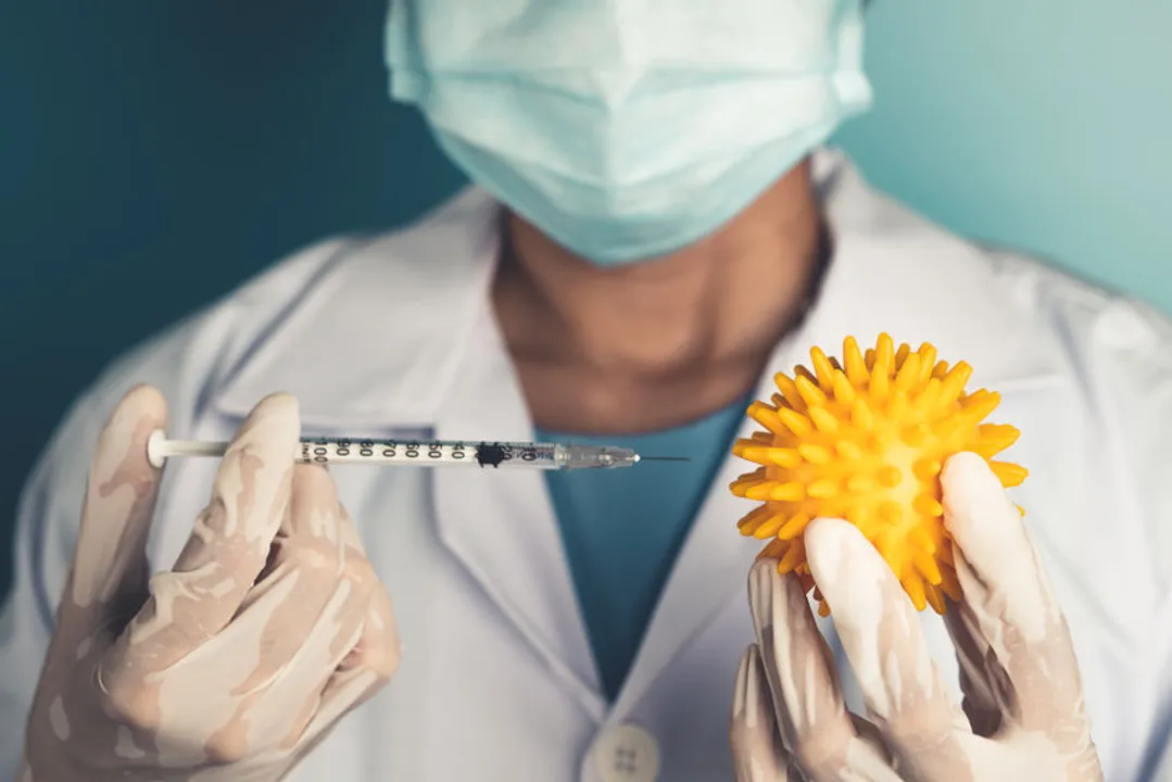 A doctor holds up a vaccine to the coronavirus