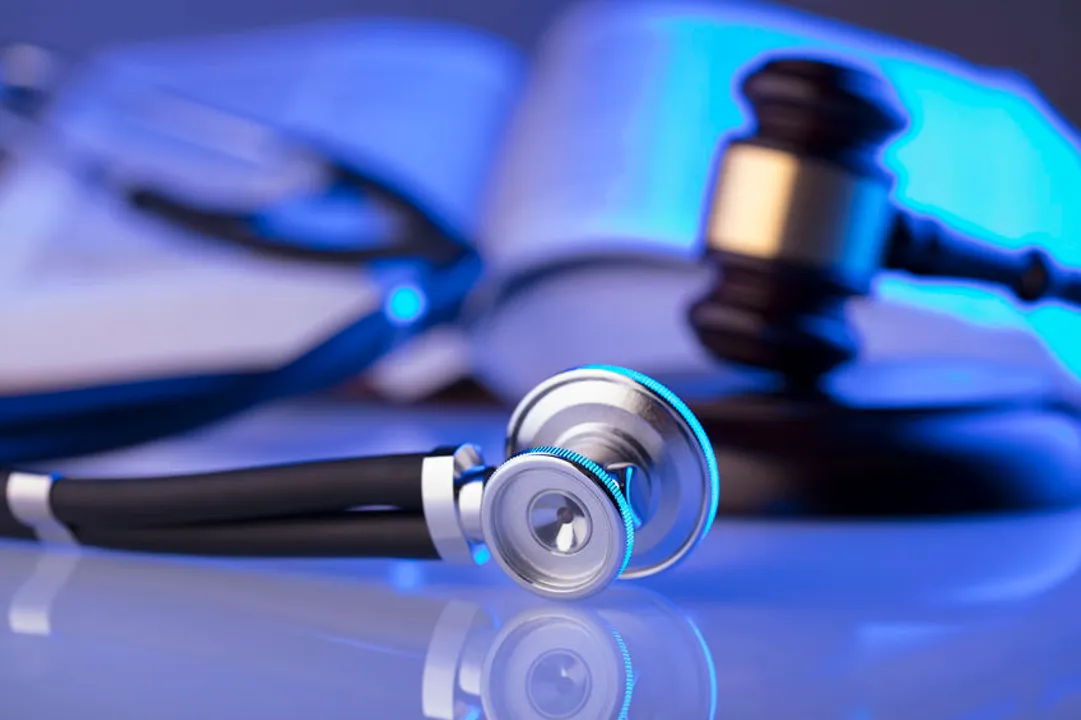 Medical law concept. A judge's gavel next to a stethoscope and a medical text book.