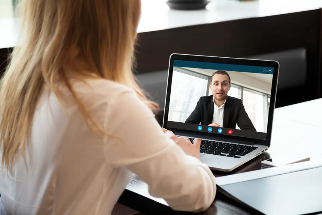 A woman talking to a man on Zoom