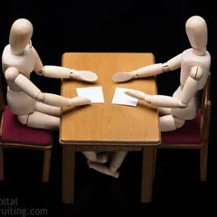 Two mannequins sitting down for a job interview