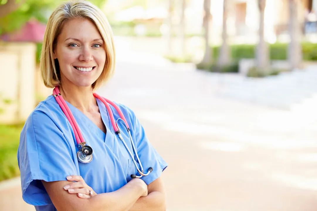 Outdoor portrait of a smiling female nurse.