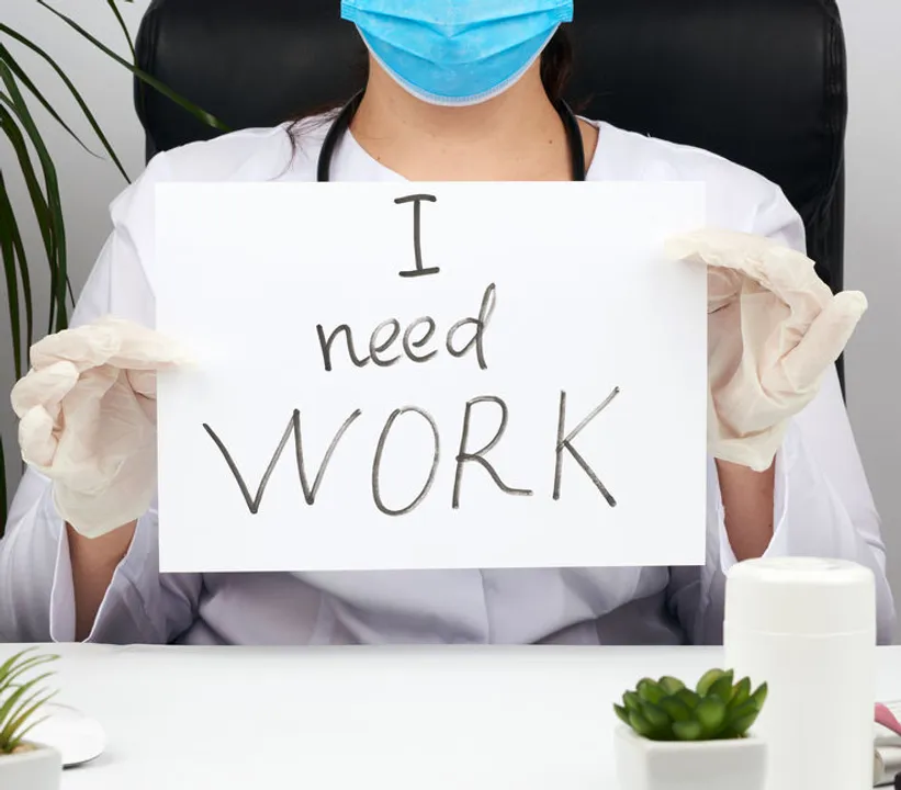 woman doctor in a white coat, sterile medical gloves holds a poster