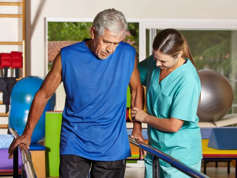 A man undergoing physical therapy for a disability