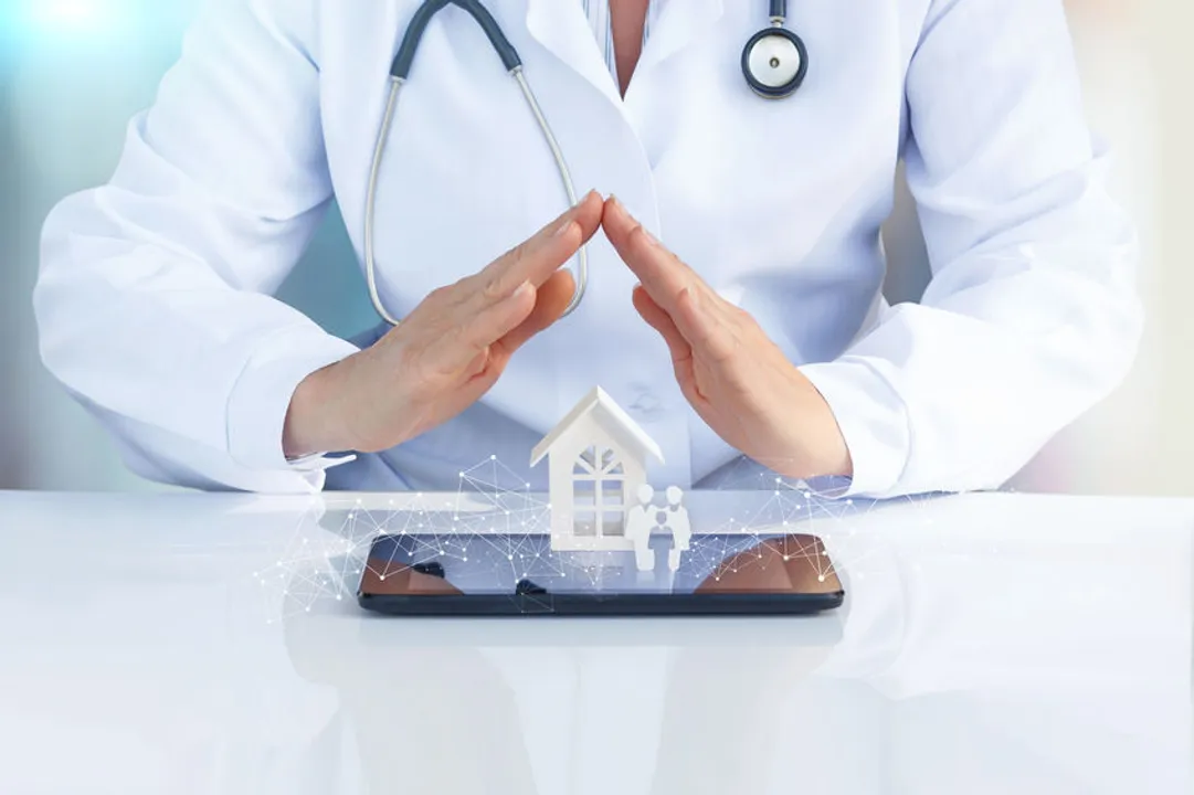 Doctor at the table working on his tablet while imagining starting a private practice